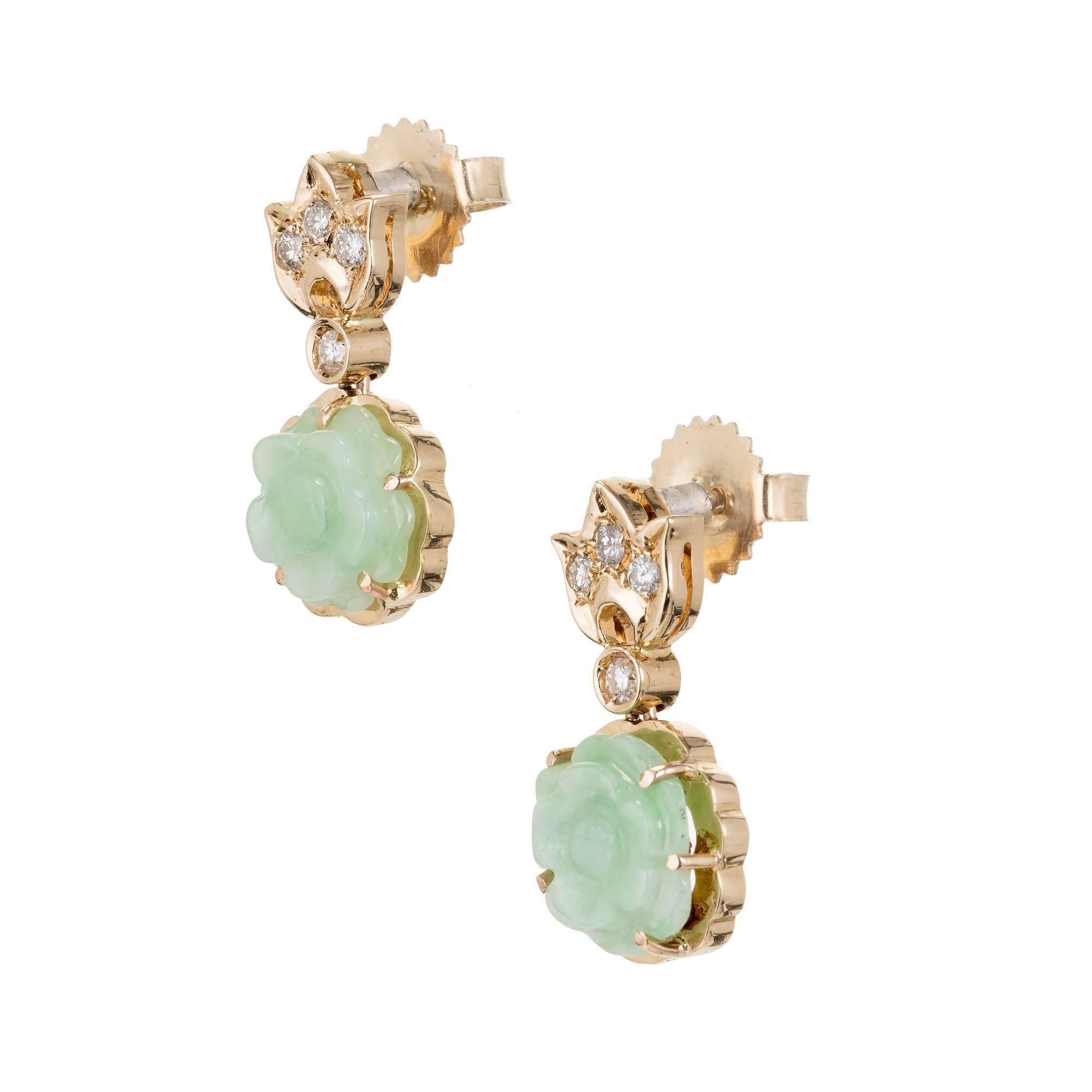 Natural carved Jadeite Jade light green flower dangle earrings in 14k yellow gold with sparkly Diamond accents. GIA certified.

2 carved light green translucent Jadeite Jade, 8.86 x 8.57 x 2.76mm, GIA certificate #2181685907
8 full cut Diamonds,