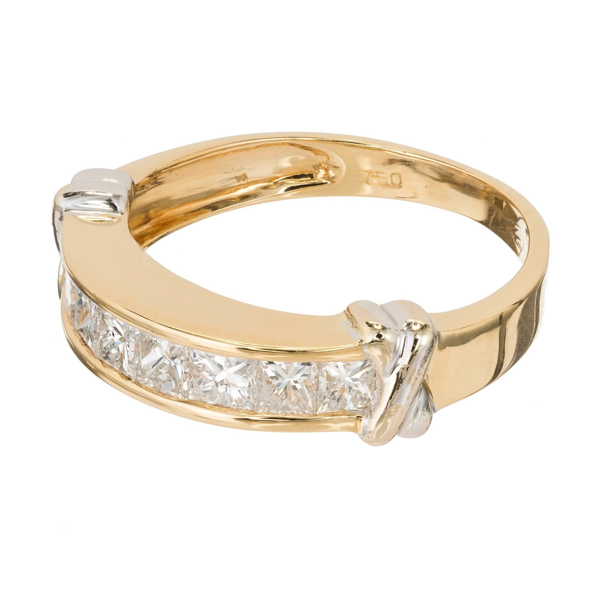 Vintage 1980s channel set Princess cut Diamond 18k yellow gold wedding band with white gold “X” details.

18k yellow gold
8 Princess cut Diamonds, approx. total weight .80cts, G – H, SI1
Tested: 18k
Stamped: 750
Hallmark: M
Width at top: