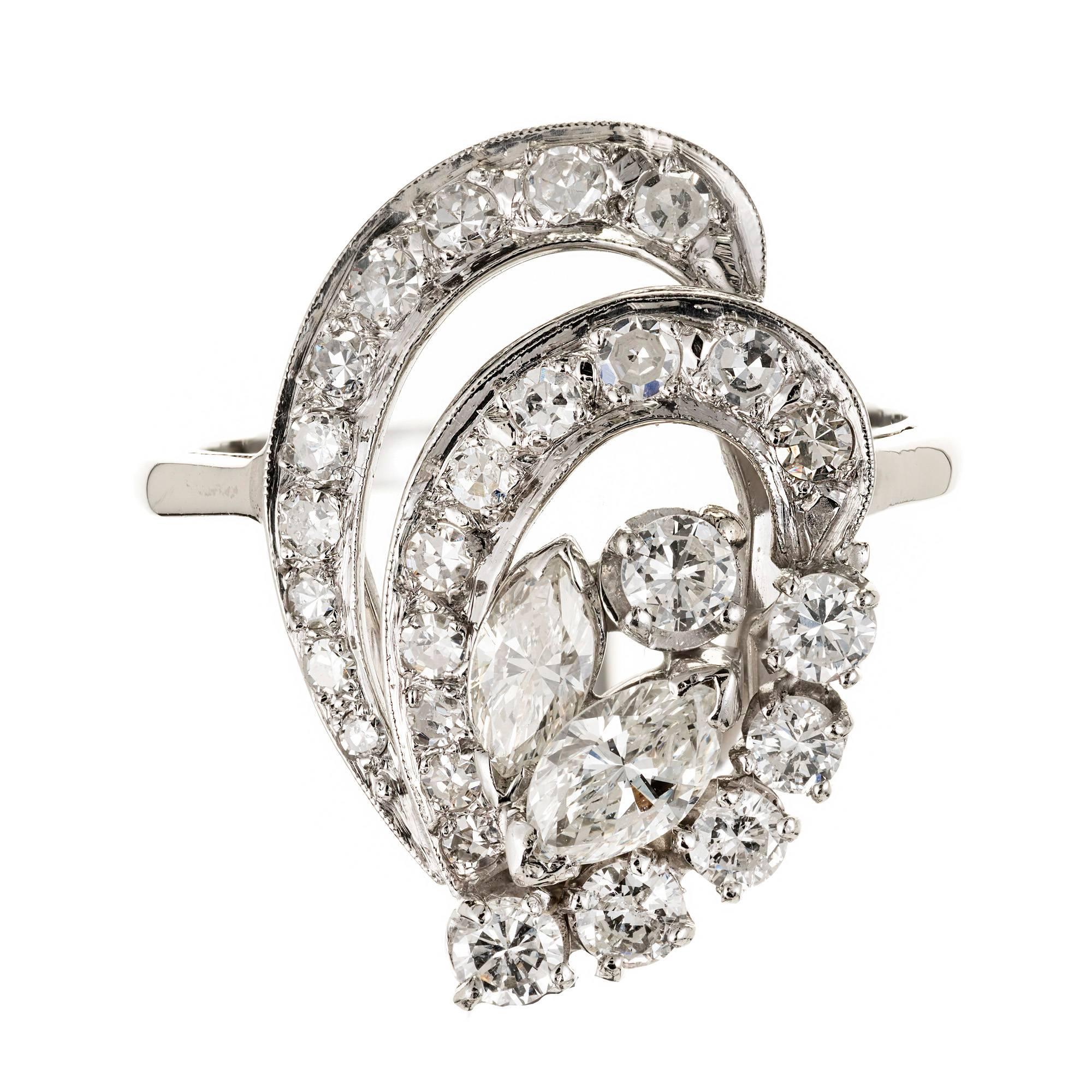 Vintage 1950s swirl Platinum ring with bright sparkly Marquise and round Diamonds. Mid-century open work ring.

2 Marquise Diamonds, approx. total weight .38cts, VS, 6 x 3.3 x 2.2mm
6 round full cut Diamonds, approx. total weight .40cts, H – I, VS –
