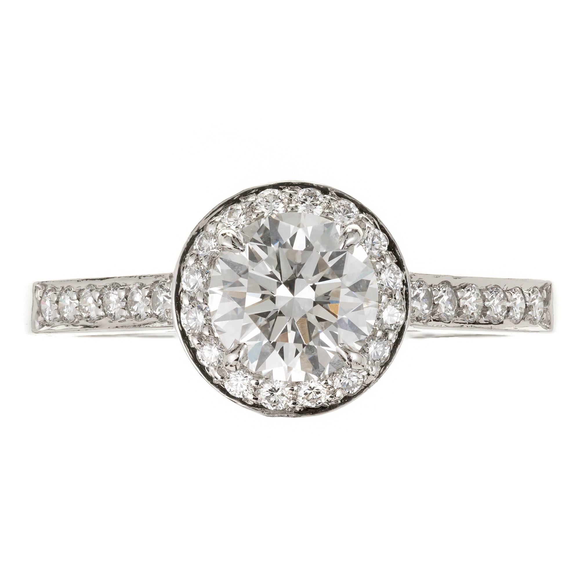 Authentic Tiffany & Co Diamond halo engagement ring. The center Diamond approx. total weight .76cts. with round accent diamonds in a platinum setting.

1 round Diamond, approx. total weight .76cts, H, I-F, Tiffany & Co L09130301 27316875
28 round