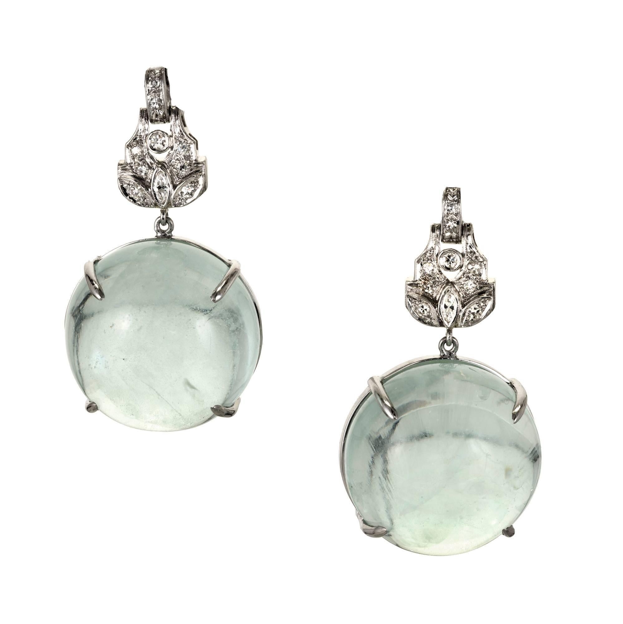 Peter Suchy Aqua and diamond Platinum dangle earrings. Platinum tops are hand beaded and bezel set with old cut Diamonds. In the bottom of each is a natural untreated large round Aqua cabochon dangle with unusual rainbow inclusions.

2 round