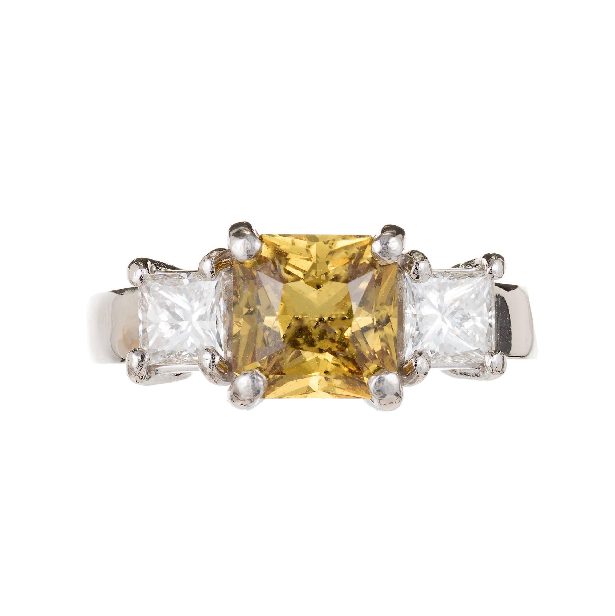 Peter Suchy GIA Certified bright golden yellow natural octagonal step cut 2.32 carat sapphire engagement ring. Two princess cut side diamonds in a platinum setting.

1 Octagonal Yellow Sapphire SI approximate 2.32 carats. GIA Certificate#