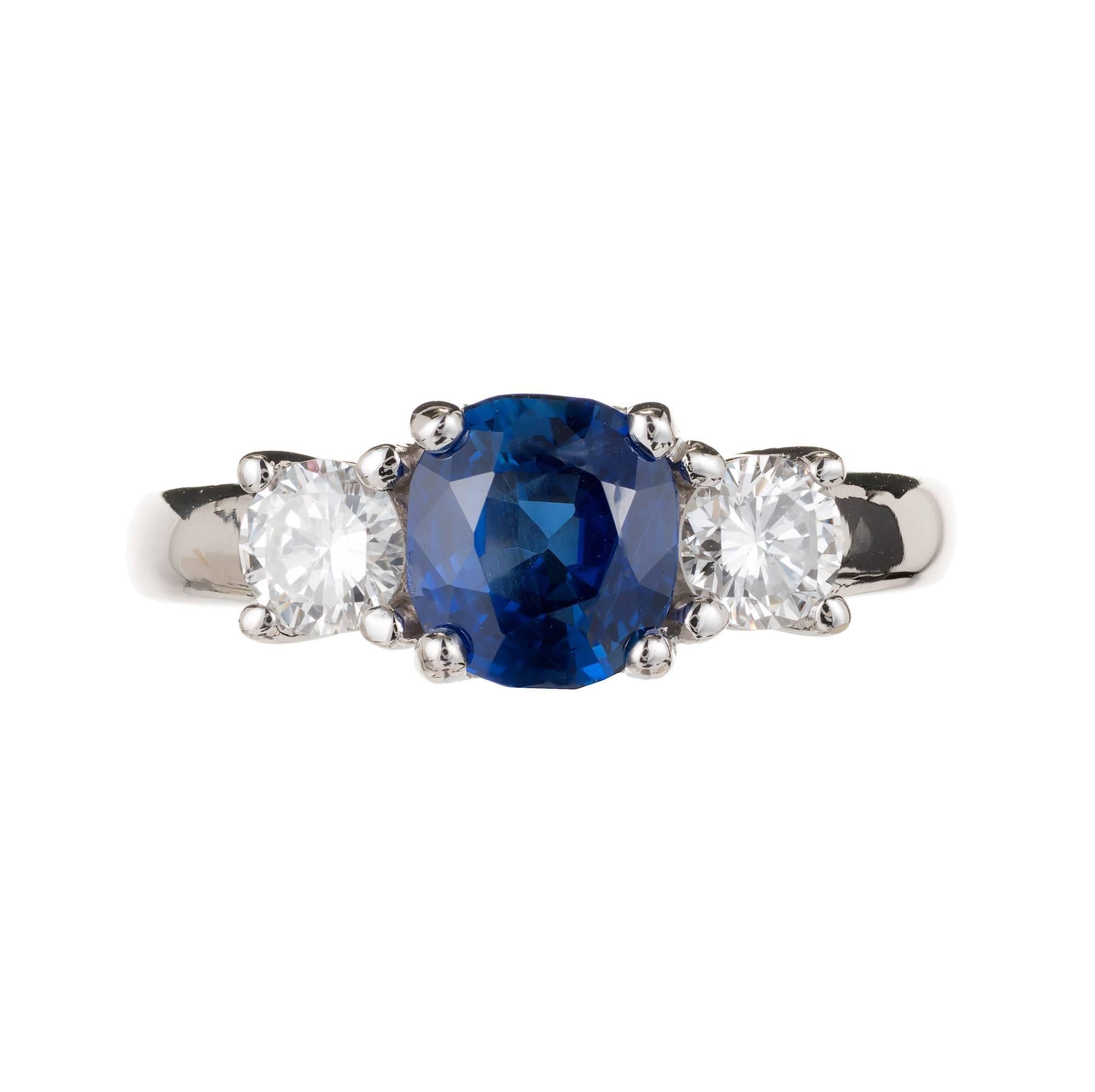 Peter Suchy three-stone sapphire and diamond diamond engagement ring in 14k white gold. GIA Certified natural no heat cushion sapphire 1.93 carats.

1 cushion bright blue no heat sapphire approximate 1.93 carats. GIA Certified 6183684776
2 round