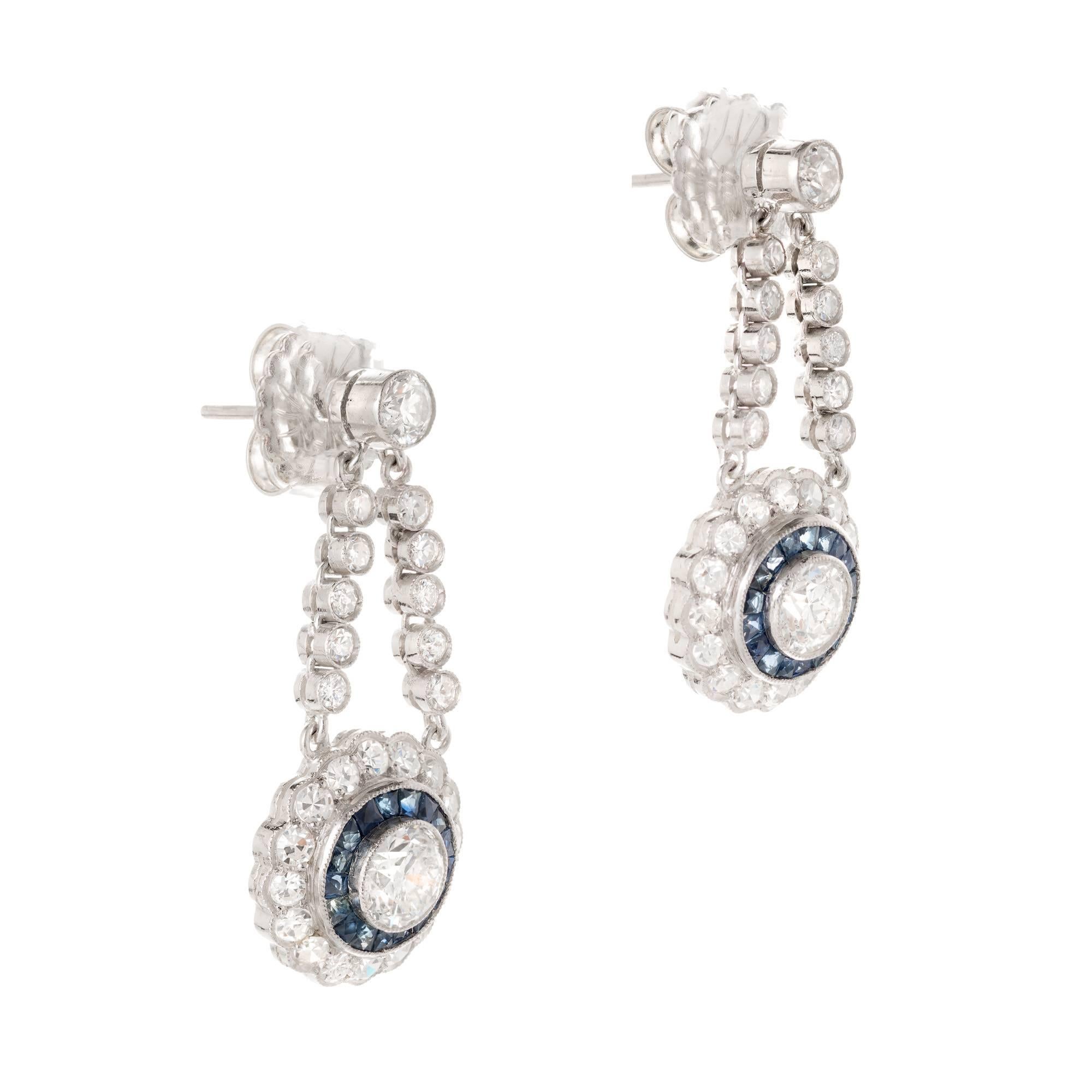 Vintage Art Deco platinum dangle earrings. Set with fine transitional cut bright white diamonds and French cut sapphires. Circa 1930

1 transitional round diamond F-G I approximate .72 carats. EGL Cert # US3141538015
1 transitional round diamond G-H