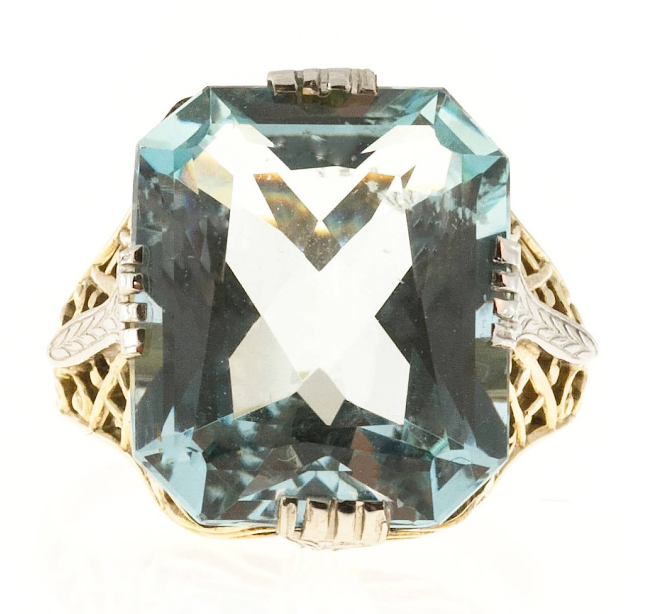 Totally original filigree 10k yellow and white gold ring with natural untreated 7.13ct  Emerald cut Aqua.

1 Emerald cut natural light greenish blue Aqua, approx. total weight 7.13cts, VS, 13.7 x 11.5mm
3.0 grams
Tested and stamped: 10k
Width