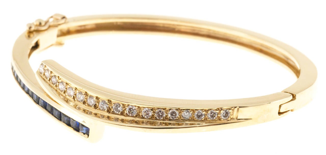 Solid 14k yellow gold Sapphire diamond bangle bracelet. Double figure 8 safeties.

17 full cut diamonds, approx. total weight .50cts, H, SI1
18 square Sapphires, approx. total weight .40cts
14k Yellow Gold
Tested: 14k
29.4 grams
Width at top: