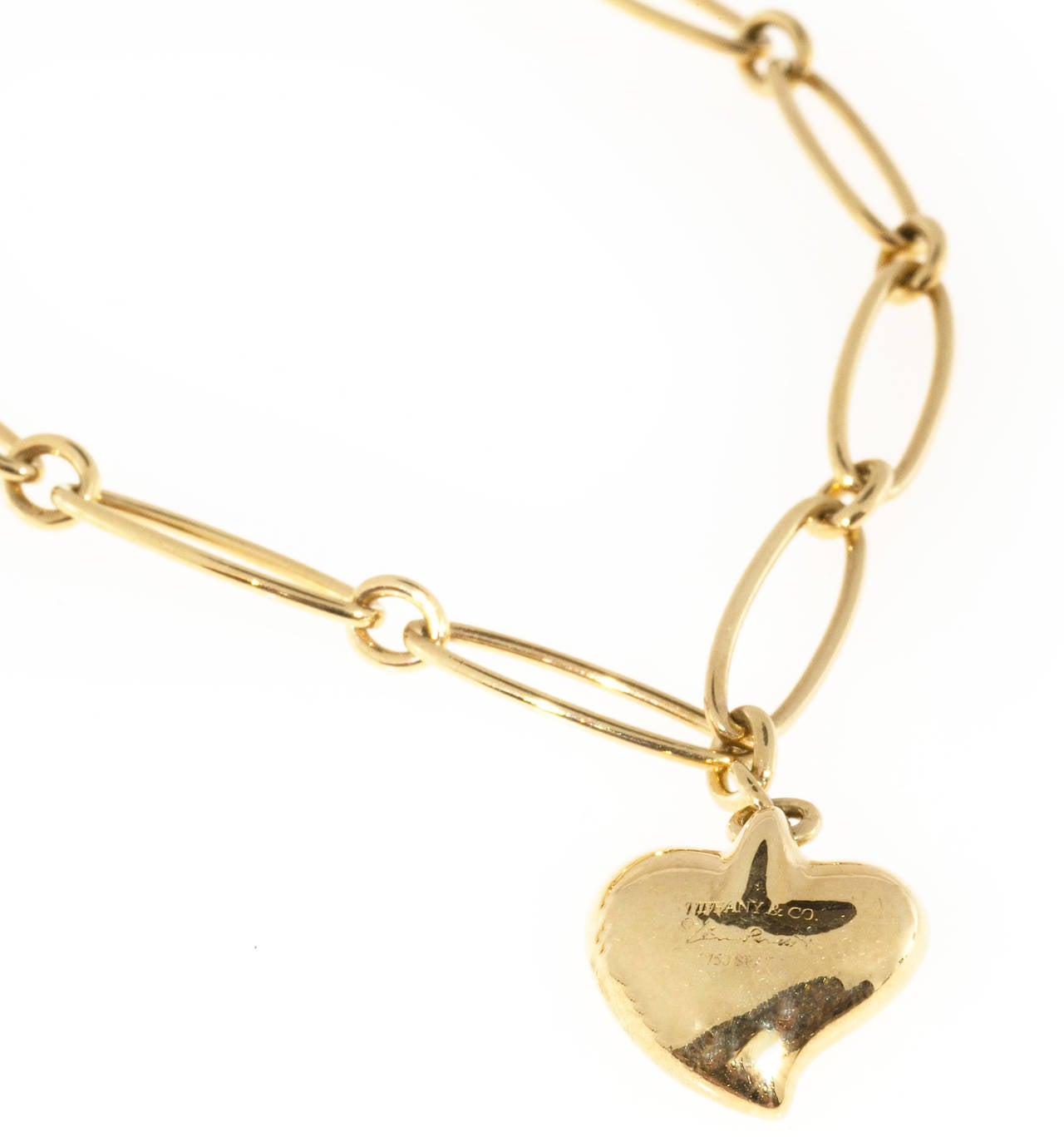 Tiffany & Co. Elsa Peretti Gold Heart Charm Bracelet In Good Condition In Stamford, CT
