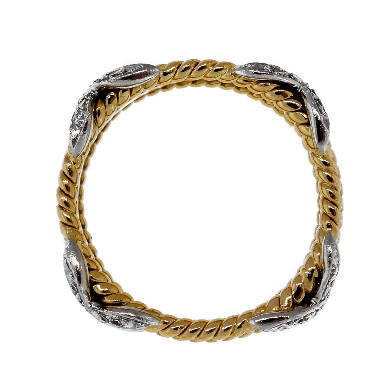 Tiffany & Co Schlumberger Diamond and Yellow Gold Platinum three row “X”  rope ring.

36 round diamonds, approx. total weight .28cts, F-G, VS
18k yellow gold and Platinum
7.1 grams
Tested: 18k & Platinum
Stamped: 750 PT 950
Hallmark: Tiffany