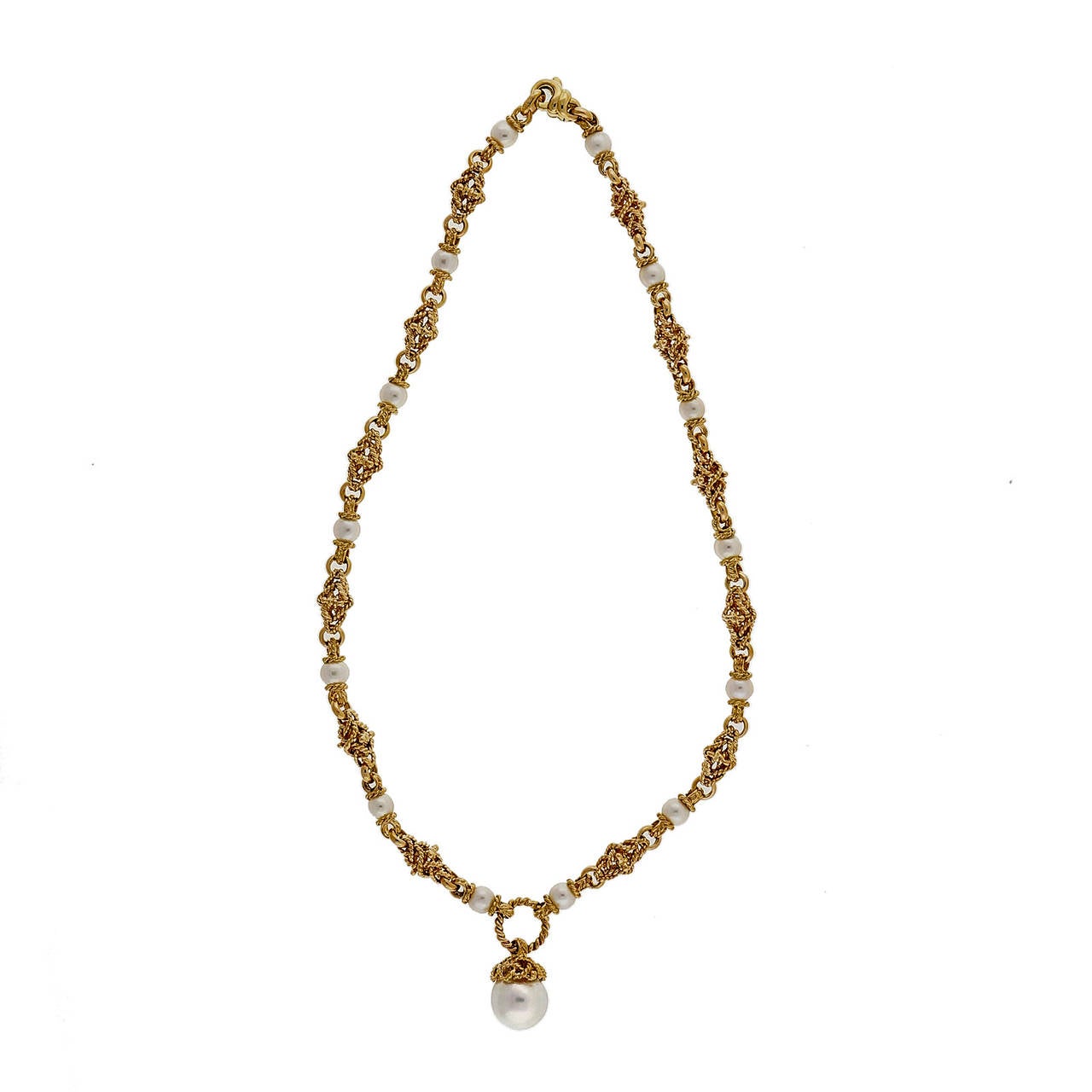 1960 Italian 18k yellow gold 3-D swirl textured section necklace with a South Sea cultured pearl center and cultured pearls through the chain.

14 Japanese white cultured pearls, 6.12mm, good lustre and few blemishes
1 South Sea white cultured