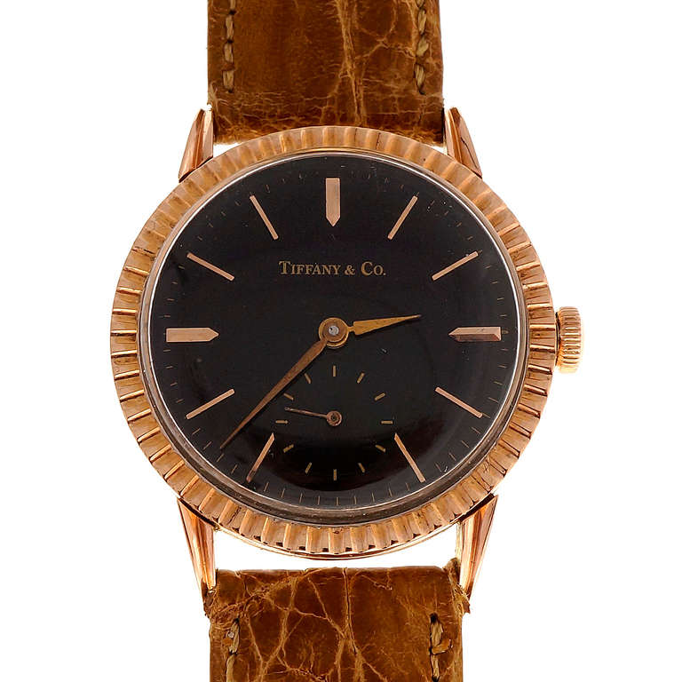 1950 14k pink gold Longines with distinctive fluted pink gold bezel. Rare older redone shiny black Tiffany & Co black dial. Sub second hand. Excellent condition, no repairs or defects. Looks great on the wrist.

14k Pink gold 
30.6 grams 
© 1950