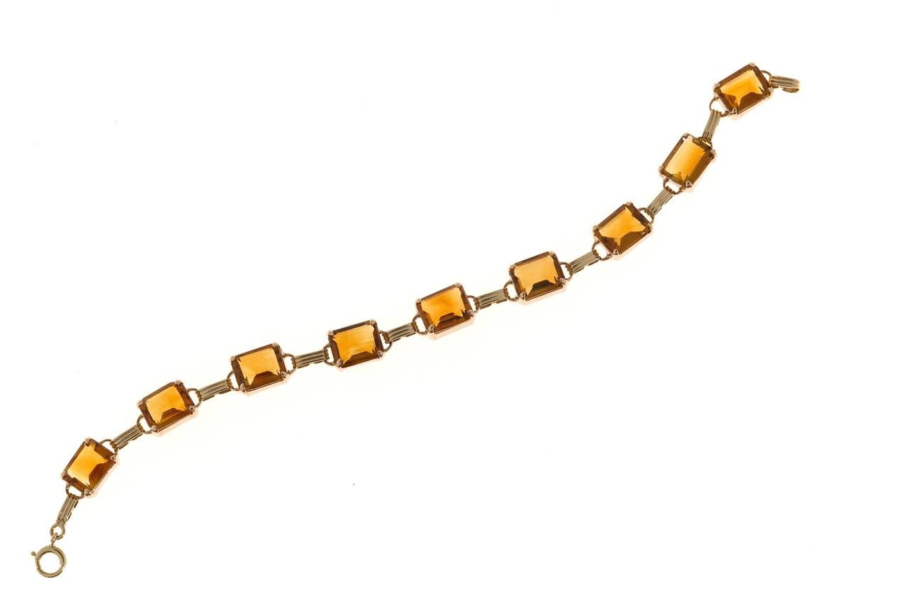 Retro Art Deco 14k pink gold hinged link bracelet with genuine untreated orangey yellow Citrine. On a pink gold scale of 1 to 10 with 10 as the deepest pink this scores a 4. Circa 1940's.

Genuine Madera Citrine untreated orangey yellow, approx.