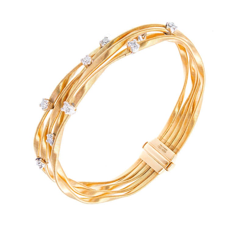 Designer Marco Bicego Marrakech bracelet. Fine strands with .45ctcts of bright white diamonds. Excellent condition. Looks great on the wrist.

8 full cut diamonds, approx. total weight .45cts, F, VS 

18k Yellow gold 
29.3 grams 
Stamped: