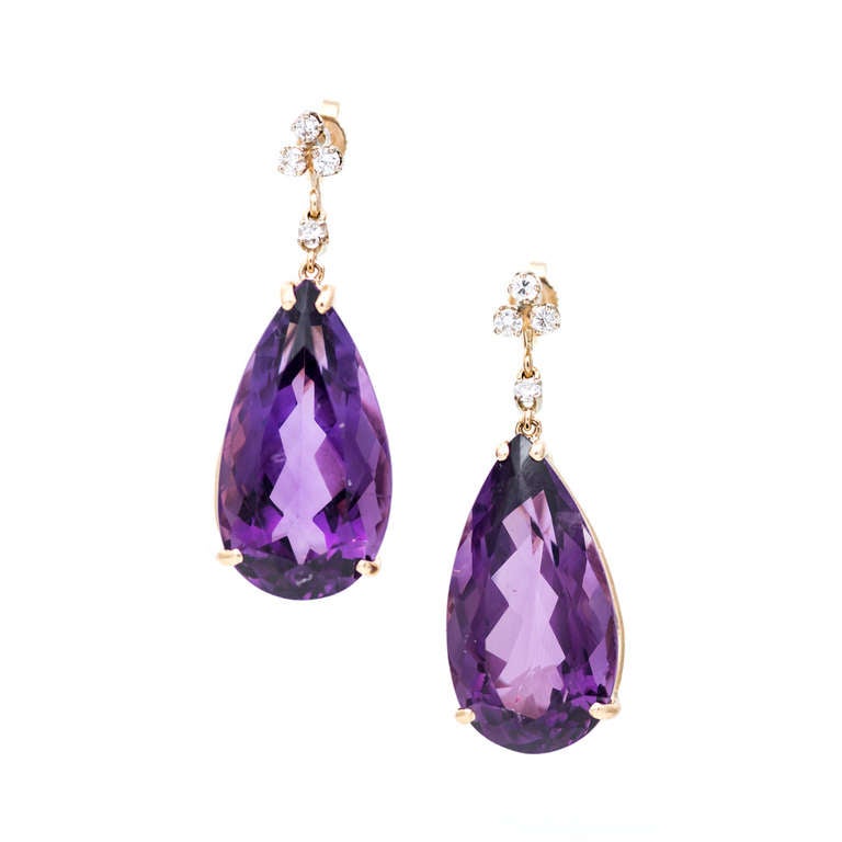 1940-1950 dangle earrings with well-polished bright purple Amethyst and diamond accents. Hand done with white gold diamond settings.
14k Yellow gold.

2 pear shaped genuine bright medium purple Amethyst, approx. total weight 36.00cts, VS2, 24 x