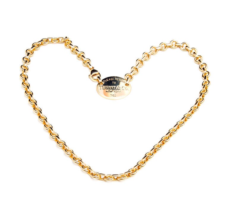 Authentic circa 1980 oval tag solid 18k yellow gold Return To Tiffany & Co necklace. Excellent condition. Looks great on the neck. Well polished.

42.3 grams
18k Yellow gold
Stamped: 750
Tested: 18k
Hallmark: Tiffany & Co
Length: 16 1/8