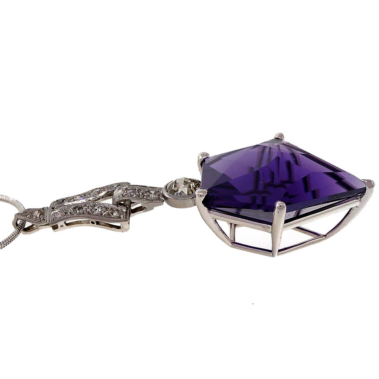 Top gem reddish purple natural Art Deco shield cut Amethyst original 1890 – 1899 pendant with an old European cut diamond and an Art Deco dangle diamond top. Platinum snake chain may be later. One of the finest Amethyst we have seen.

1 shield gem