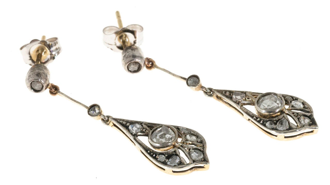 Victorian handmade 1860 to 1870 dangle earrings with yellow gold backs and Sterling silver tops set with all original rose cut diamonds.

18 rose cut diamonds, approx. total weight .30cts, I, SI
Tested: 14k & Sterling
Stamped: Sterling &