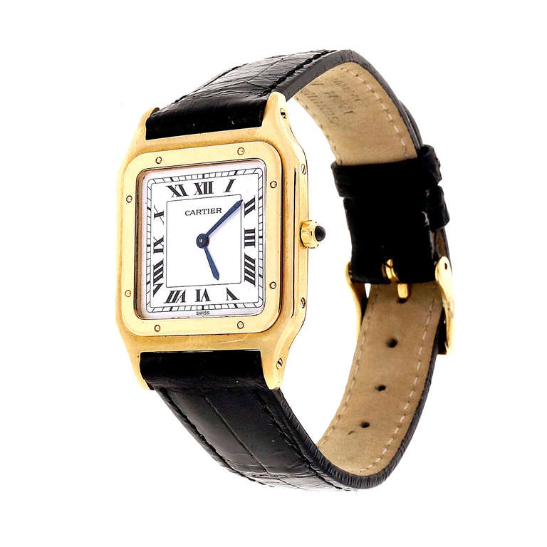 Solid gold 18k Cartier Santos manual wind wrist watch. Keeps great time. Suitable for a man or woman. 

36 x 27mm.
18k Yellow gold
28.5 grams
Tip: 36.31mm
Width without crown: 27mm
Width with crown: 29.51mm
Band width at case: 17mm
Case thickness: