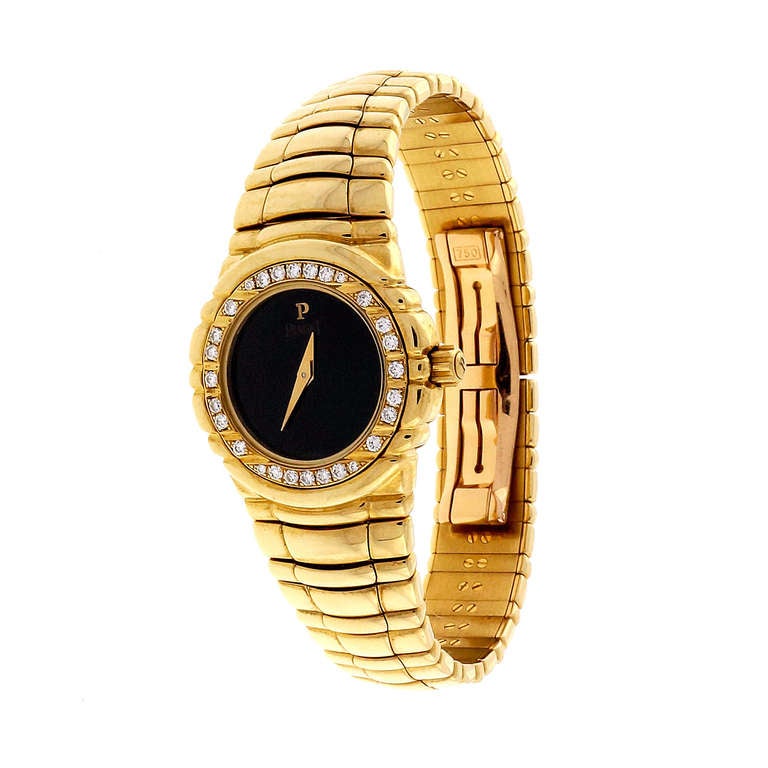 Heavy solid gold ladies Piaget watch, integrated gold band, diamond bezel. Piaget Quartz movement. 

18k Yellow gold
84.2 grams
Length: 6.75 inches
Tip: 26mm
Width without crown: 24.6mm
Width with crown: 27.1mm
Band width at case: 18.6mm
Case