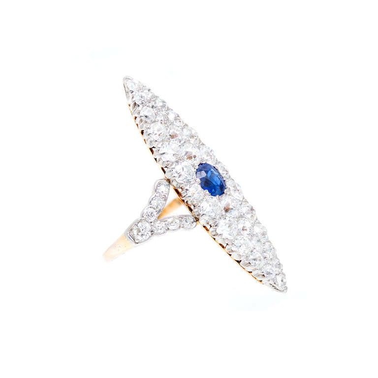 Victorian 1900 elongated marquise shape sapphire and diamond cocktail ring, Set with one oval sapphire and European cut diamonds. Natural no heat. Handmade in 14k yellow gold with a platinum top. AGL certified

Yellow Gold and Platinum
1 oval