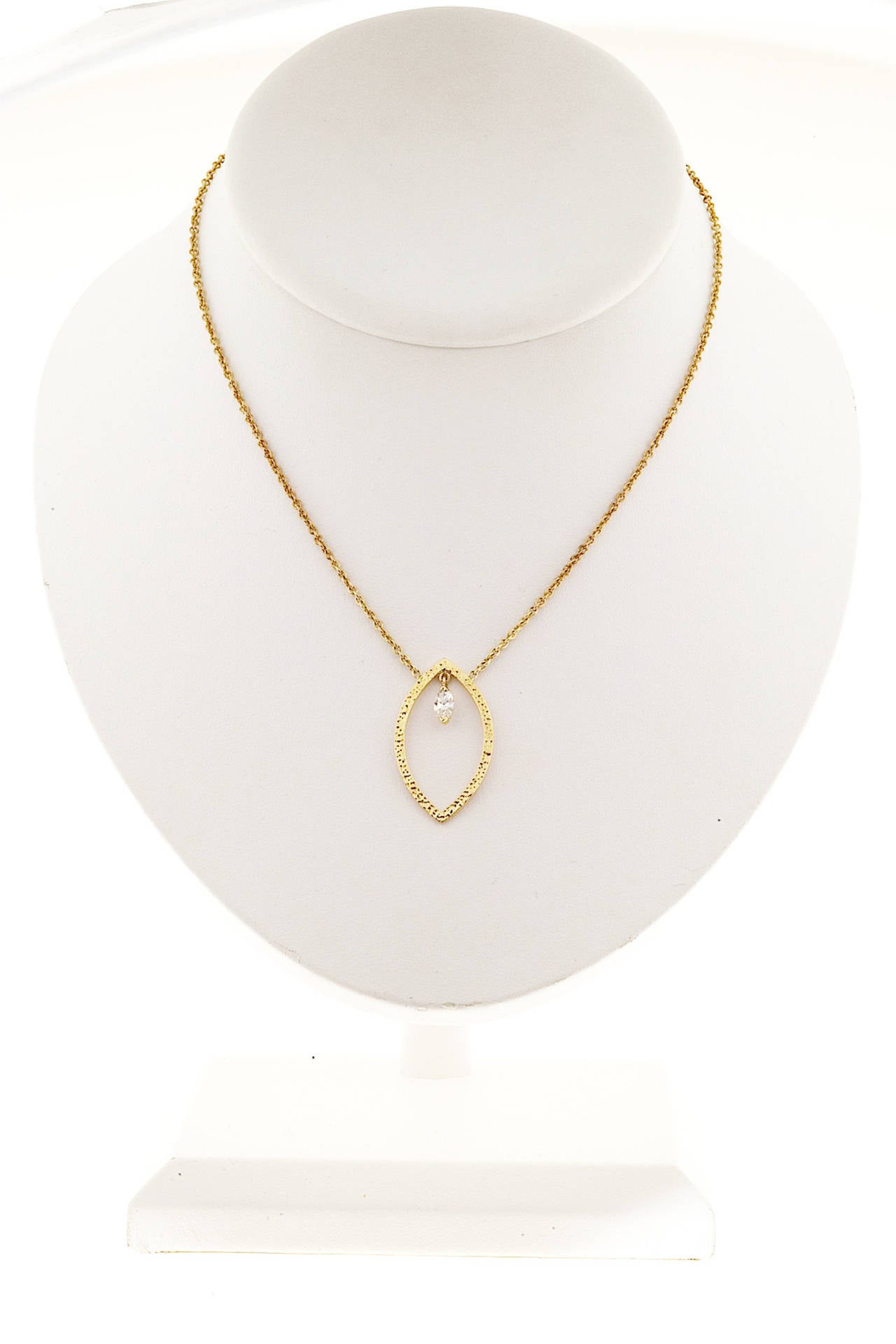 Designer Jade Trau 18k yellow gold open Marquise pendant with a Marquise diamond in the center.

1 Marquise diamond .27cts, H, VS2 to SI1
18k Yellow Gold
Stamped: 750 Jade Trau
8.4 grams
Chain stamped: 750 K18
Marquise center section: 1 1/4 x