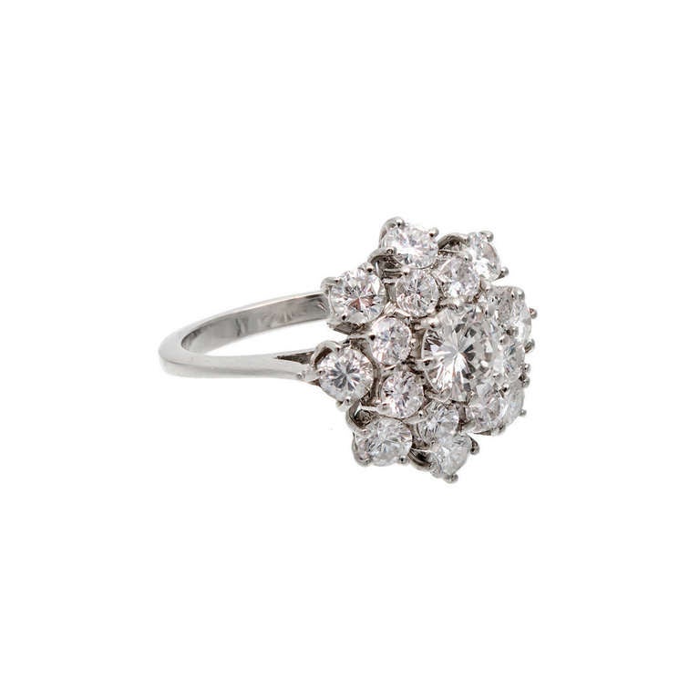 Wonderful 18k white gold raised cluster style ring set with very well cut colorless F diamonds. Most VS1 to VS2 clarity. Center diamond is SI1 and one small diamond is SI2. Approx. 2.36cts total. Circa 1960. Incredible sparkle. Excellent condition,