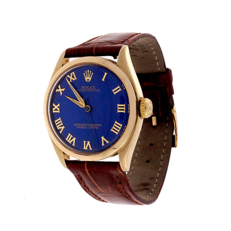 Rolex 14k yellow gold transitional bubbleback wristwatch, circa 1952, with original Rolex dial, possibly an early refinish in blue. Ref. 6084.

14k yellow gold
48.3 grams
Width without crown: 33mm
Band width at case: 19mm
Case thickness: