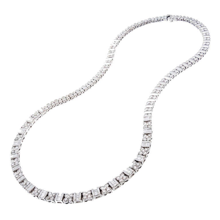 Beautiful original Greg Ruth necklace with a total of 4.56cts in round full cut and baguette diamonds Original appraisal enclosed. Excellent condition. Looks great on the neck.

68 full cut round diamonds, approx. total weight 3.19cts. I to J,
