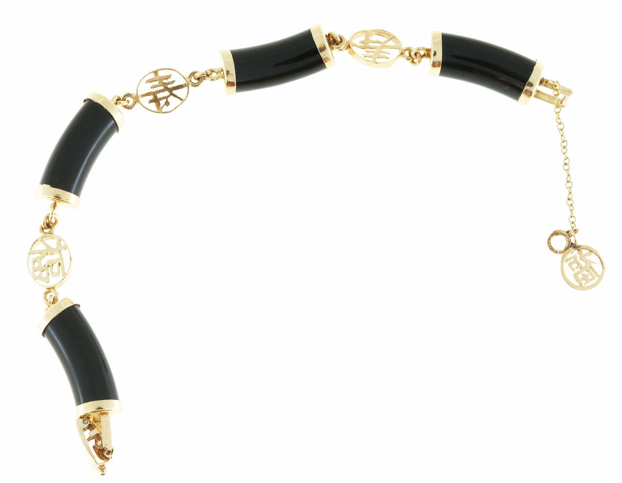 Natural black AGL certified Nephrite Jade and 14k yellow gold Chinese motif bracelet. 4 cylinders of well-polished black Jade are connected by cut out oval links with Chinese characters. Secure box catch and a safety chain.

4 AGL certified