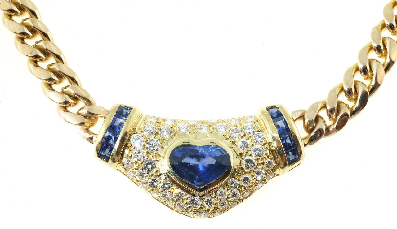 3.37ct Ceylon sapphires surrounded by pave set diamonds and calibre cut sapphires are on both sides.  18k and 14k yellow gold. 

1 Heart shaped sapphire approx. total weight 3.37cts
8 square faceted (calibre) approx. total weight 1.25cts
48 round