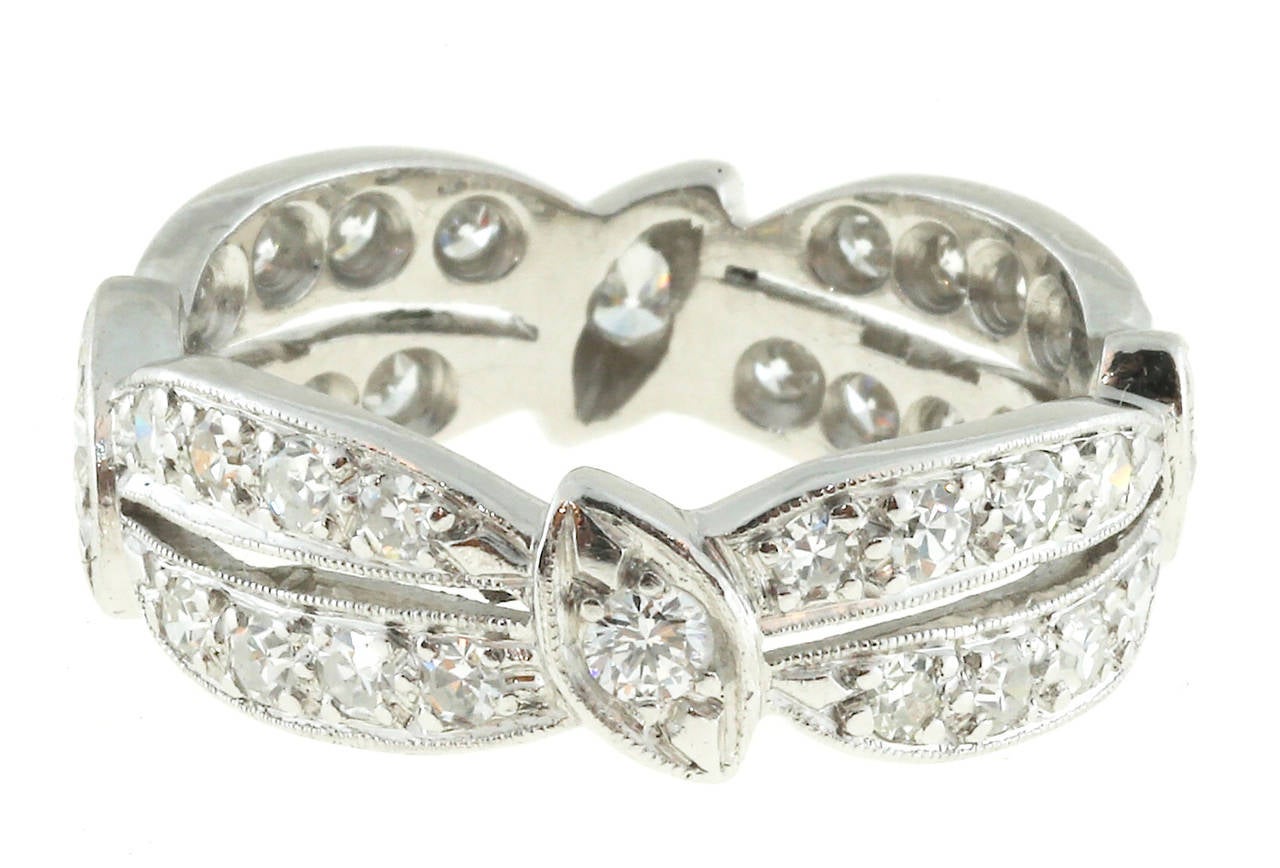 Solid Platinum pierced size 8 1/4 Eternity band.

4 full cut diamonds
32 single cut diamonds, approx. total weight .65cts, F, VS
15.5 grams
Platinum
Width: 7mm
Depth: 2.2mm
Size 8 1/4+ and not sizeable