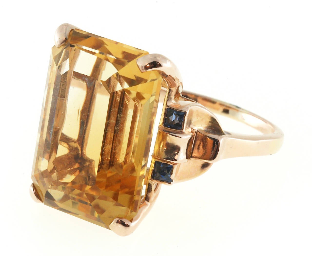 Art Deco Retro pink gold ring with a natural golden yellow 20.00ct Citrine and genuine Sapphire accents. Very good overall condition. The stone is well polished.

1 natural golden yellow Citrine approx. total weight 20.00cts, 19.5 x 14mm,