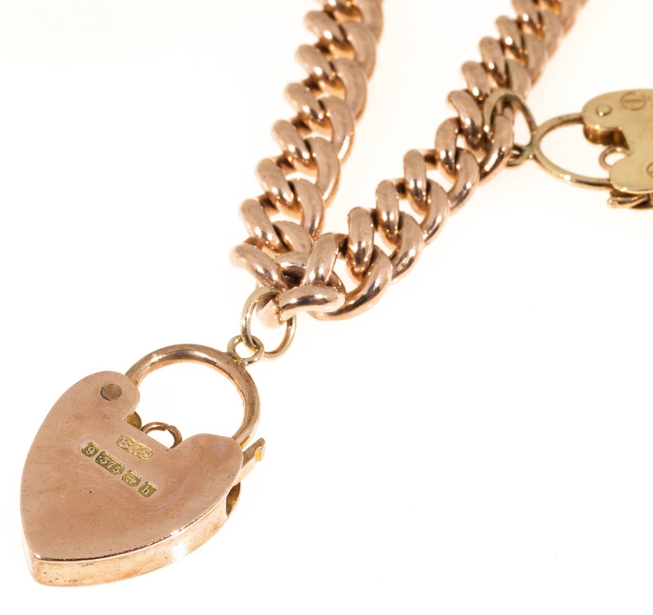 English 9k gold hollow link bracelet with 5 heart lock Charms. Mechanical Circa 1900-1920.

5 heart lock charms all still open including the catch .7 to 1 inch top to bottom
9k Gold
34.3 grams
Chain: 6.5mm wide
Chain stamped: 375
Each lock