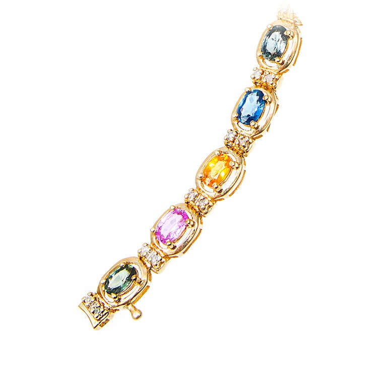 Mehrfarbiger echter Saphir 7,00ct. Armband mit Diamanttrennern. Designer NTF.  Dieses wunderschöne Tennisarmband präsentiert eine bezaubernde Reihe von mehrfarbigen, lebhaften ovalen Saphiren in Blau, Rosa, Gelb und Grün. Akzentuiert mit 40