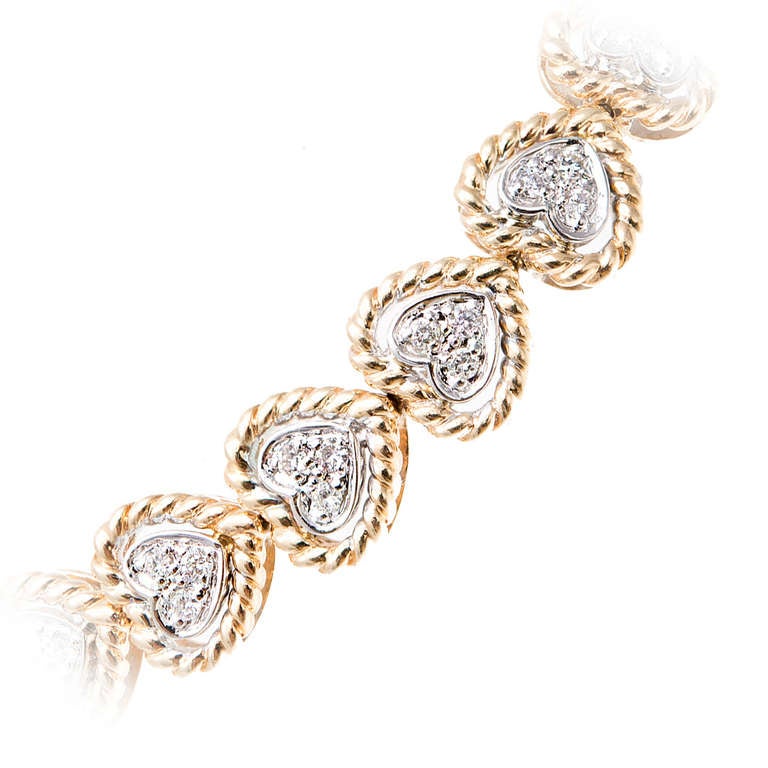 Authentic Sonia B 14k yellow and white gold heart link bracelet with full cut diamonds. 

75 full cut diamonds, approx. total weight .75cts, G, VS1 - SI1

Stamped: Sonia B 14k
25 heart shaped links
Width: 8mm
14k yellow and white