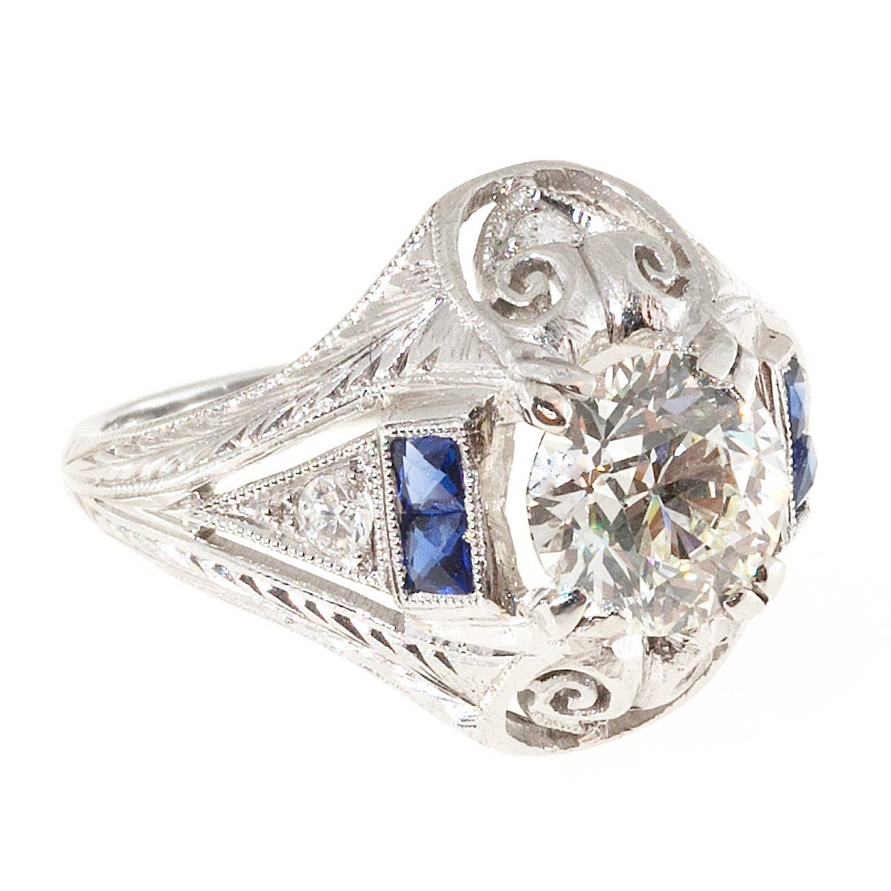 Diamond and sapphire engagement ring. Hand engraved pierced filigree platinum setting with calibre Sapphires and an old European cut diamond.

1 Ideal old European cut diamond, approx. total weight 1.31cts, I, VS1, Depth: 63.3% Table: 48% EGL