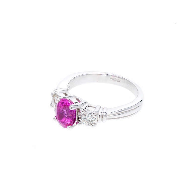 Peter Suchy 1.25cts Pink oval Sapphire and diamond three-stone engagement ring. GIA certified natural no heat no enhancement. Simple solid Platinum seitting with side diamonds.

1 oval hot pink Sapphire, approx. total weight 1.25cts, SI2, 7.65 x