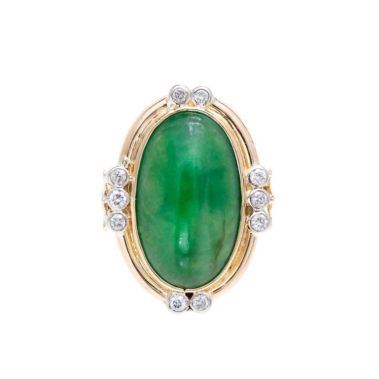 Well polished natural oval Jadeite Jade ring. 14k White and yellow gold setting with accents at top, bottom and sides. GIA certified natural color and no enhancements. 14k yellow gold 

1 oval rich green translucent Jadeite Jade, 20.25 x 11.95 x