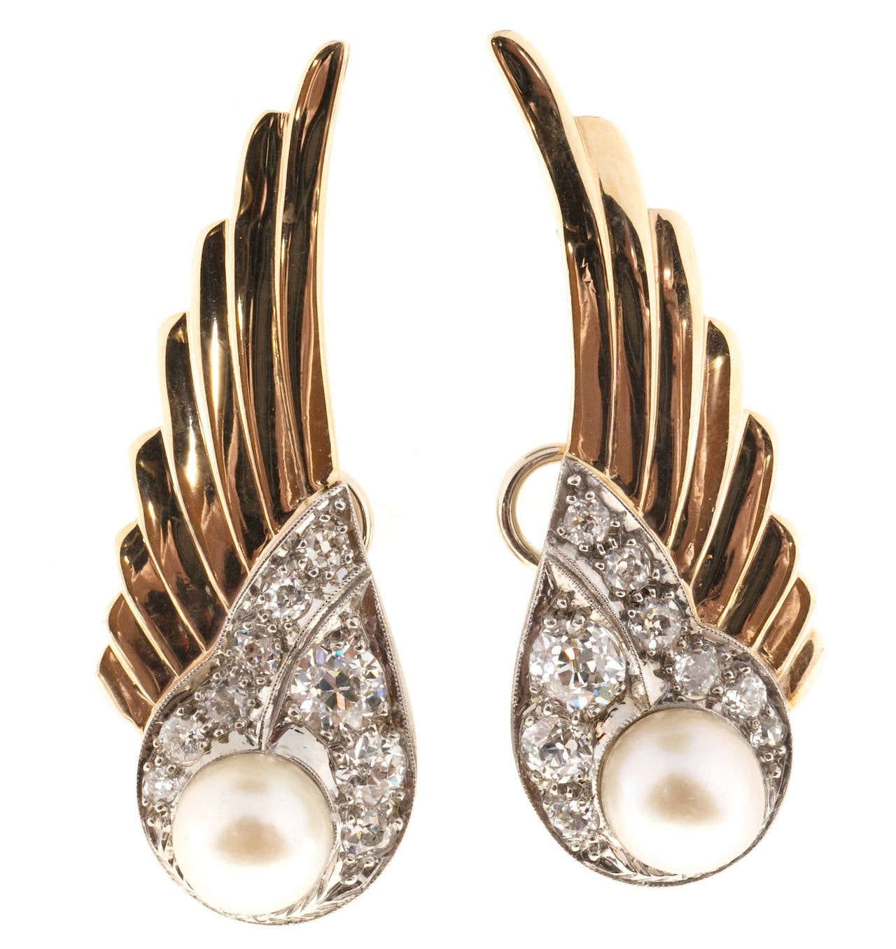 Wing design earrings are one of my favorite styles. These are a very fine example. 18k white gold bead set bottoms with European cut diamonds and beautiful silvery white pearls. The bottom section is 18k white gold. The wings are 14k yellow gold.