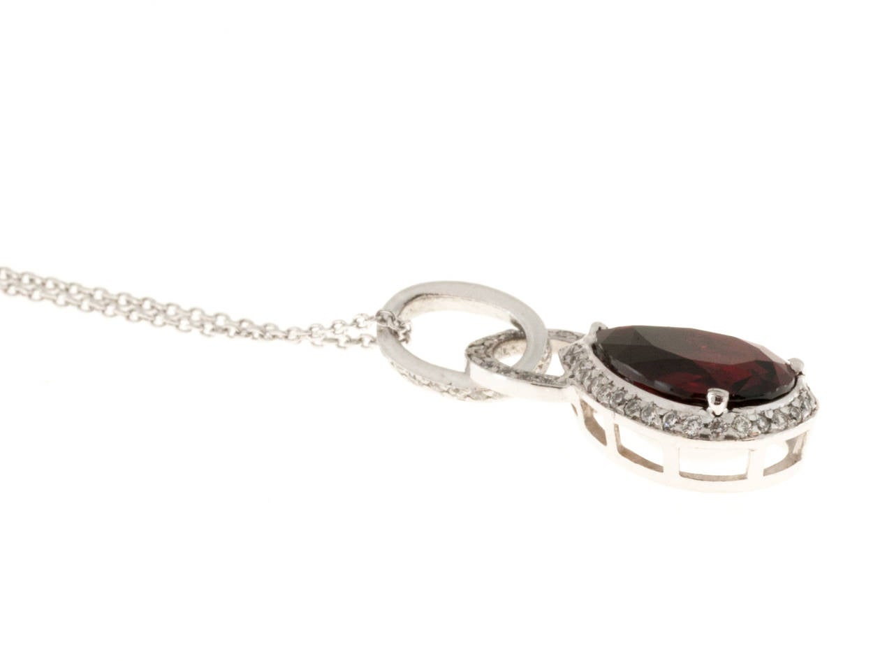 Platinum deep red Rhodolite Garnet 1.80ct pendant.

1 Pear shaped Rhodolite red Garnet 10 x 7mm, approx. total weight 1.80ct
54 round full cut diamonds, approx. total weight .25cts, G, VS
Platinum
4.8 grams
Pendant stamped: 950 18k