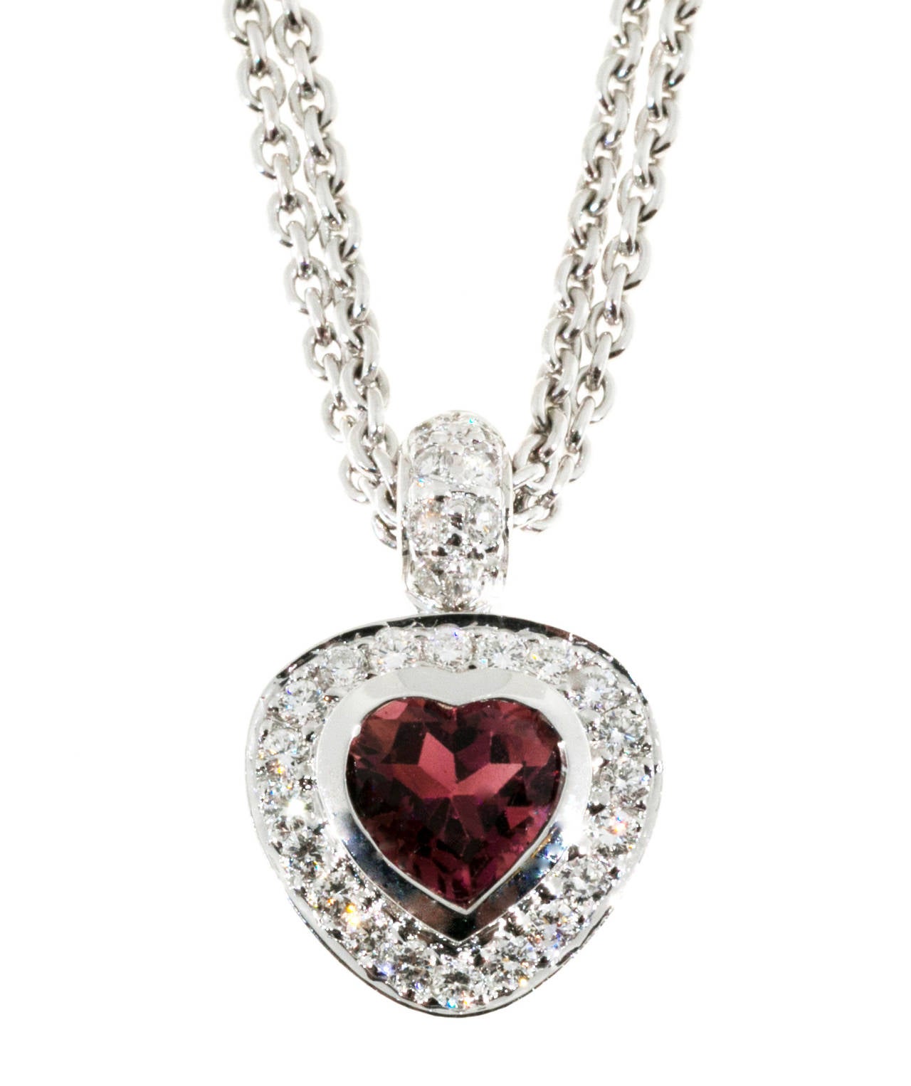 Outstanding 14k white gold hot pink tourmaline and pave diamonds designer heart pendant on an interesting two strand cable link chain. All diamonds are full cut. F, VS2.

1 heart shaped pink tourmaline approx. total weight 1.50cts
28 round