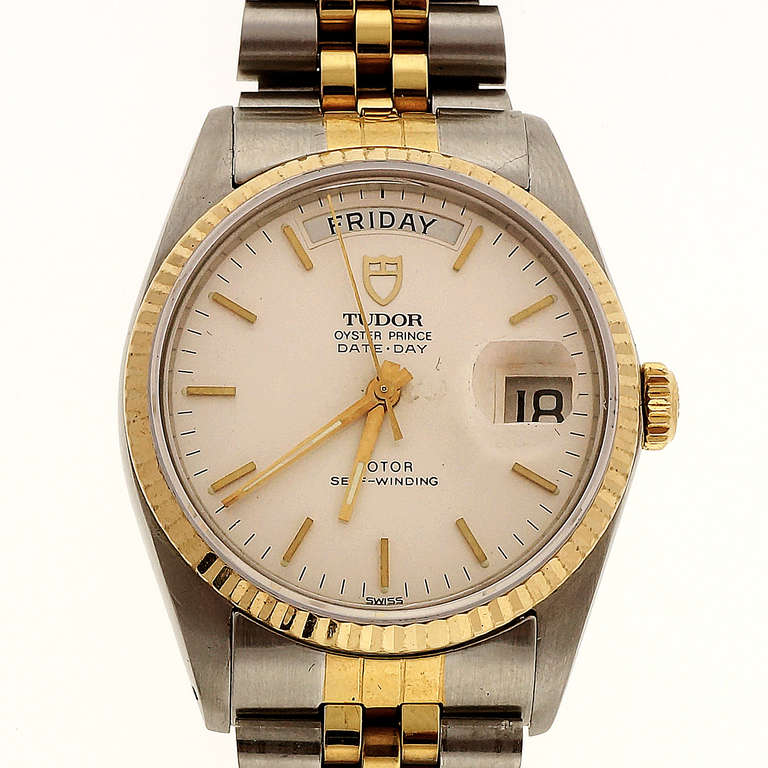 Tudor stainless steel and gilt metal Day-Date wristwatch, automatic, sapphire crystal, circa 1988.
                                           
Width without crown: 35.4mm 
Width with crown: 38mm 
Band width at case: 20mm 
Case thickness:
