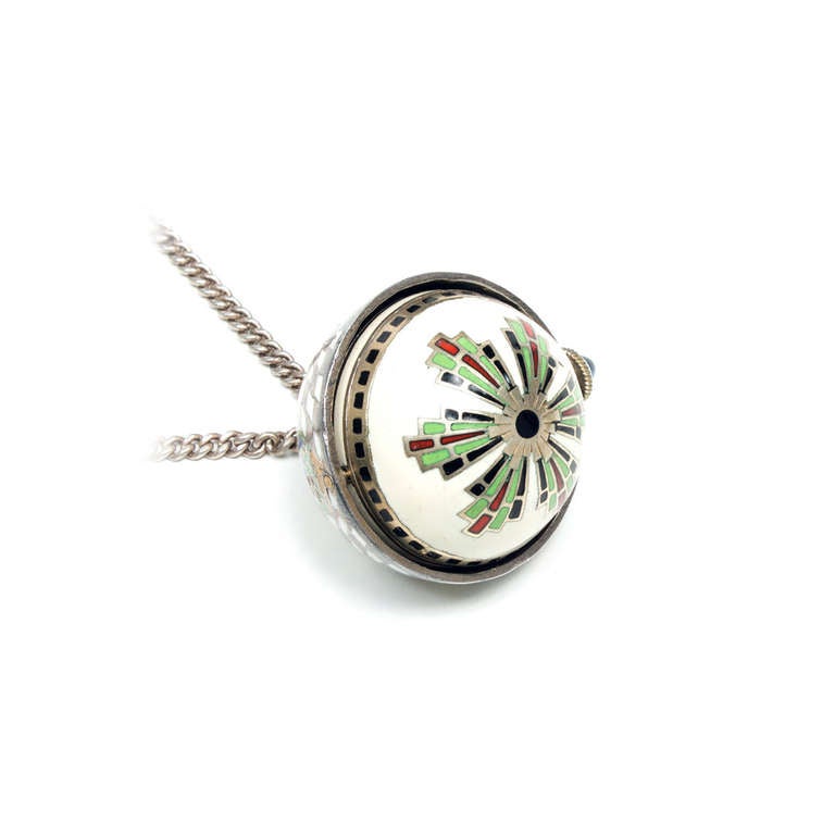 Art Deco lady's sterling silver and enamel ball-form pendant watch on a silver chain, circa 1925. The bottom half turns over to reveal the beautiful multi-color enamel.

Sterling silver
28.4 grams
Chain Length: 26 inches
Width without crown: