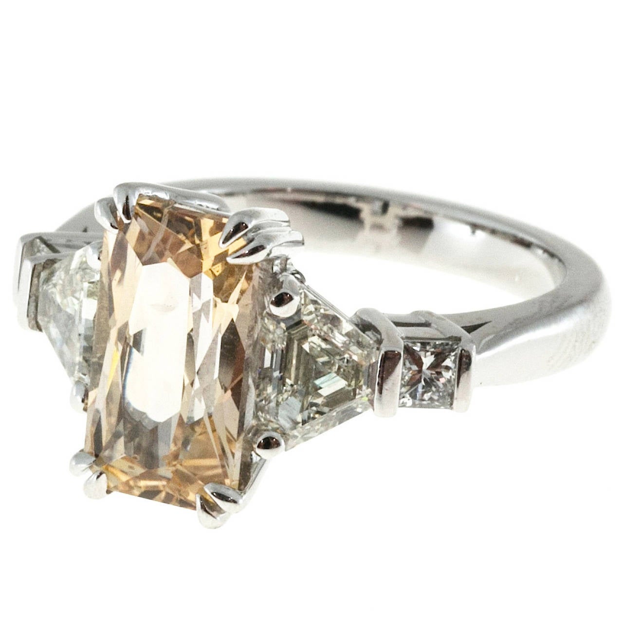 From the Peter Suchy workshop, rectangular orange yellow natural Sapphire center stone. Handmade platinum setting accented with trapezoid and square brilliant cut side diamonds.  No heat and no enhancements. GIA certified, 

3.31ct octagonal Art