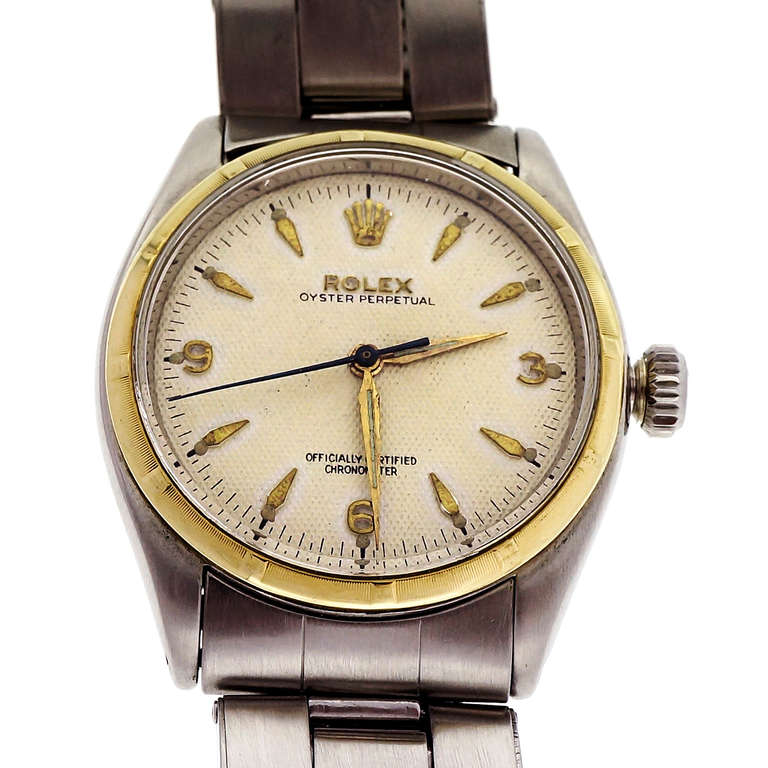 Rare transitional bubbleback Rolex from 1957, Ref. 6285, with stainless steel case and 14k yellow gold bezel. Self-winding movement, silvered dial with natural patina, applied gold markers. Riveted Oyster bracelet.

Stainless steel and 14k yellow