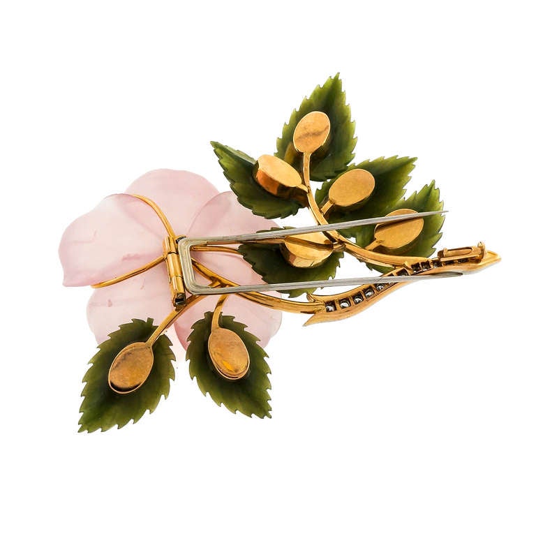 1950's Hand carved 3-D intricate 14k gold flower brooch with rose Quartz, Jade and round Diamonds.Secure double pin Stem.

14k Yellow and white gold
1 carved translucent pink rose quartz, VS
7 translucent Nephrite Jade leaves, 21 x 13mm
6 full cut