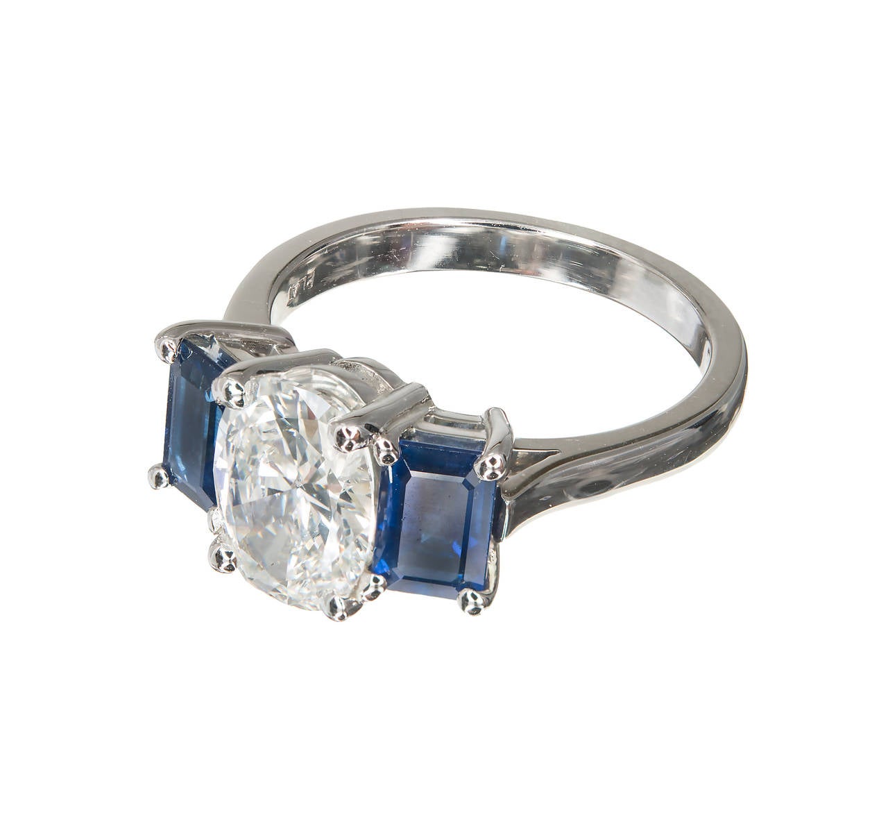 Beautiful oval diamond, extra bright and sparkly. Very white and eye clean. Matched with 2 estate Sapphires fine deep blue Emerald cut and simple heat only. Peter Suchy Design ring PSD. Circa 1960.

1 oval diamond, approx. total weight 1.58cts, H,