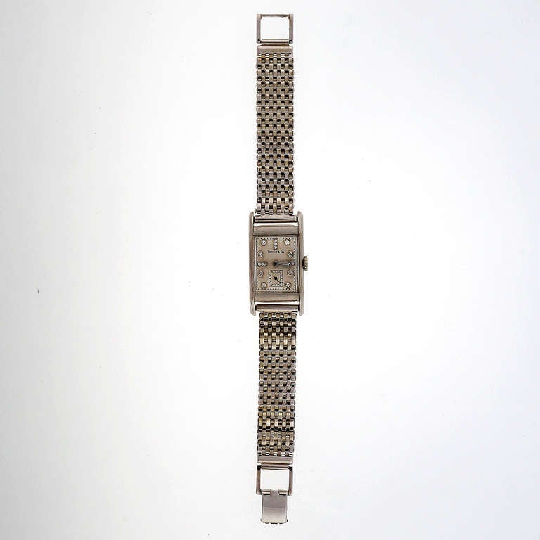 Longines palladium rectangular wristwatch, circa 1940s, with diamond dial, retailed by Tiffany & Co. With white gold bracelet probably added later.

14 single cut diamonds.

Length of bracelet: 7.25 inches
Width without crown: 20.48mm
Width