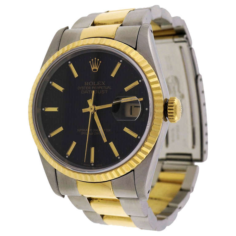 Rolex stainless steel and 18k yellow gold Datejust wristwatch, Ref. 16233, circa 1991, with Oyster bracelet, black pinstripe dial, green seal still on the back.

Stainless steel and 18k yellow gold
Bracelet length: 7.75 inches
Top to bottom: