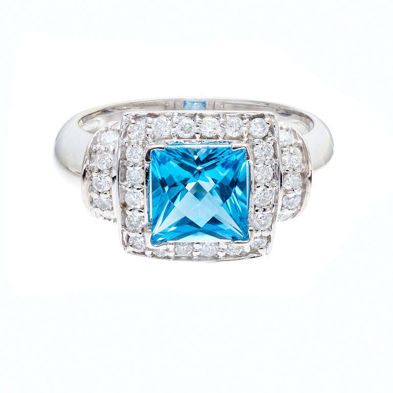 Square top bright blue Topaz with full cut diamonds in a 14k white gold ring. 

14k White gold 
One 7.1mm cut London blue Topaz Princess, approx. total weight 2.00cts, VS
31 full cut diamonds, approx. total weight .75cts, G-H, SI1 
Size 7.75 and