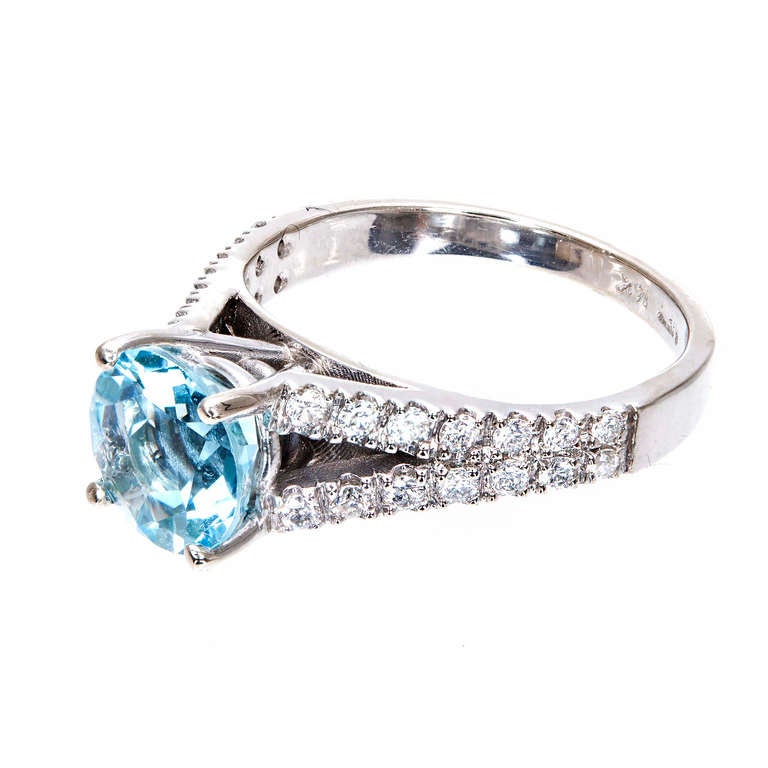 Natural Aqua and diamond 14k white gold split shank engagement ring.


One 8mm round natural untreated Aqua, approx. total weight 1.80cts 
28 full cut diamonds, approx. total weight .50cts, H, SI1 
Size 7 and sizable
14k White gold 
Tested and